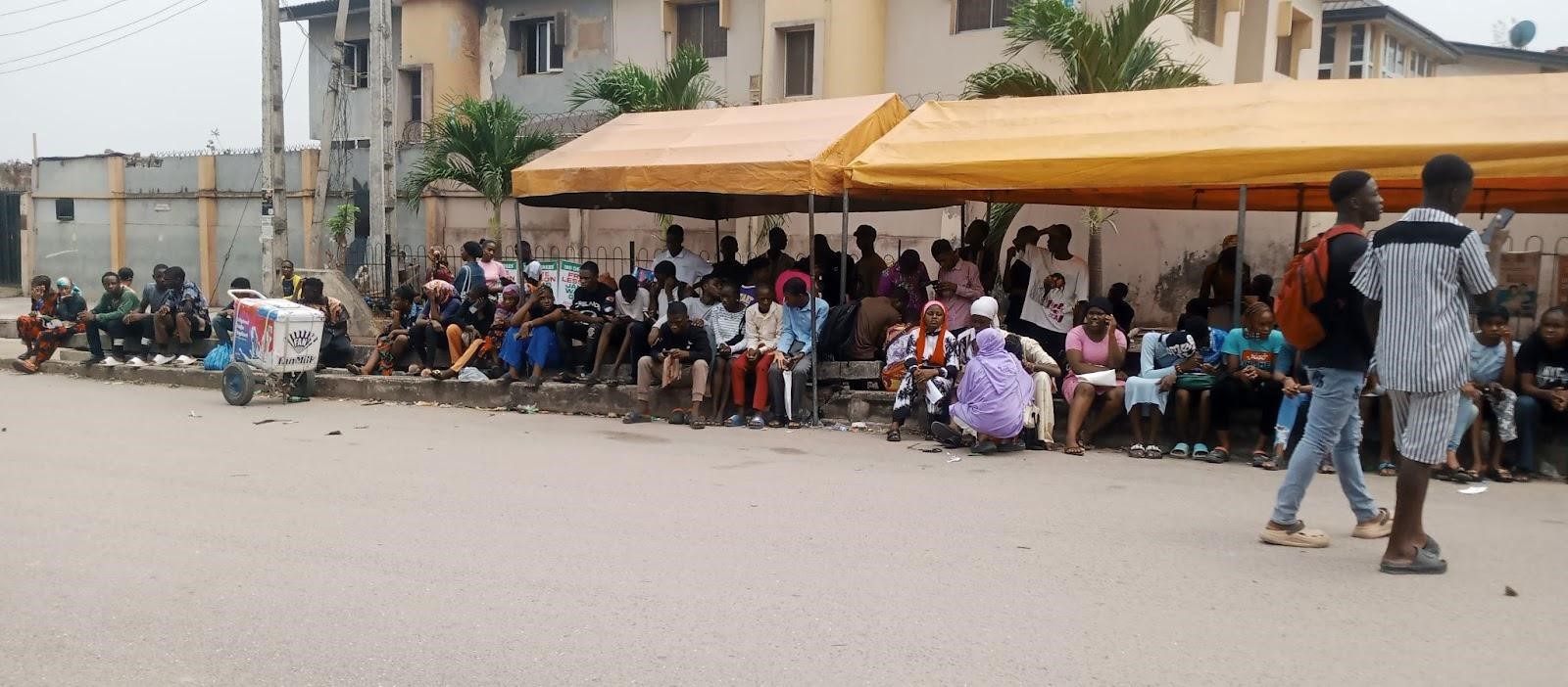 Some applicants under a makeshift canopy waiting to be attended to by JAMB officials at Mictec International Schools CBT Centre, Ojota, Lagos on Tuesday. Photo: Sodiq Mojibola